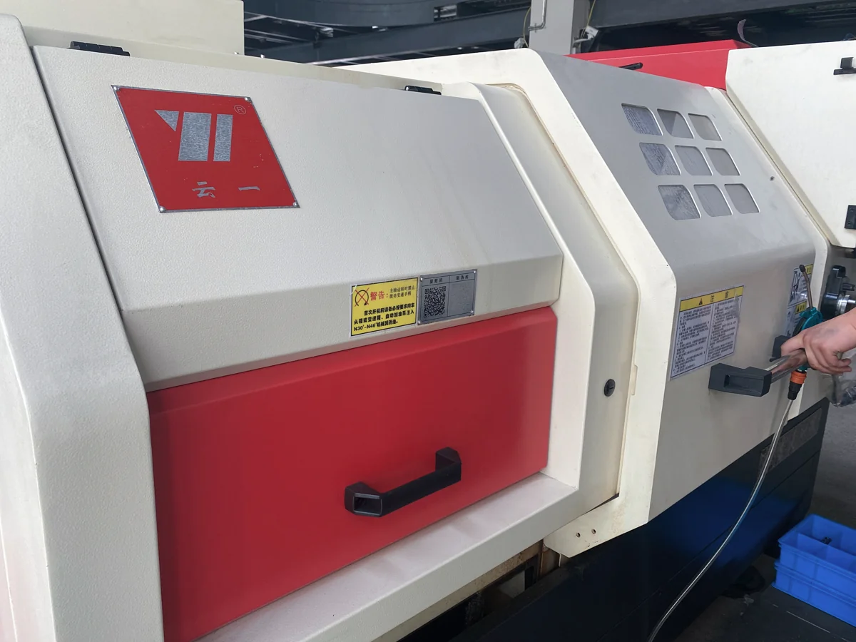 Enclosed CNC turning machine in the metal processing workshop