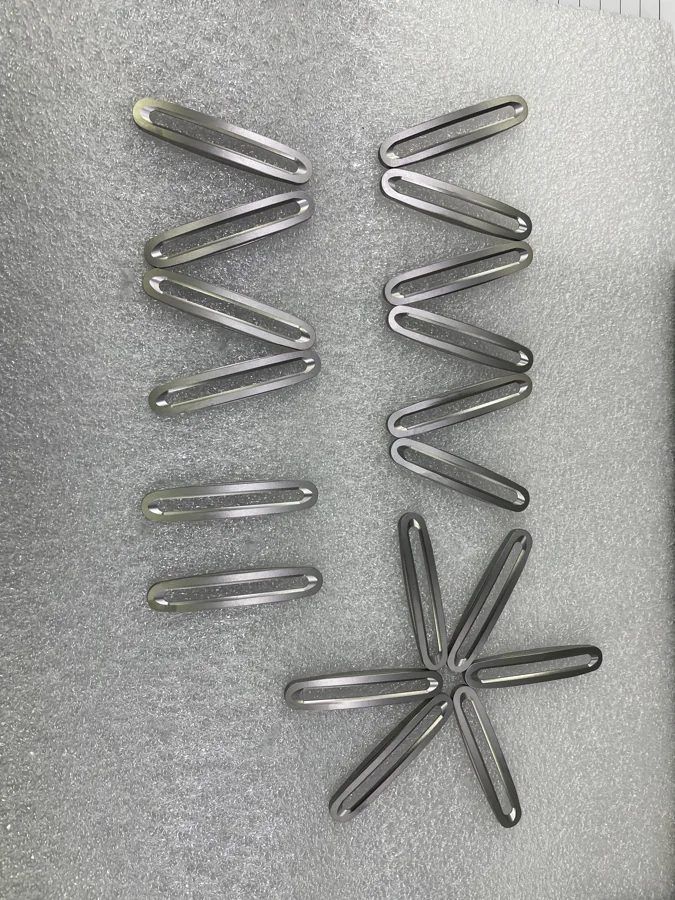 Formed metal components with bends and support features
