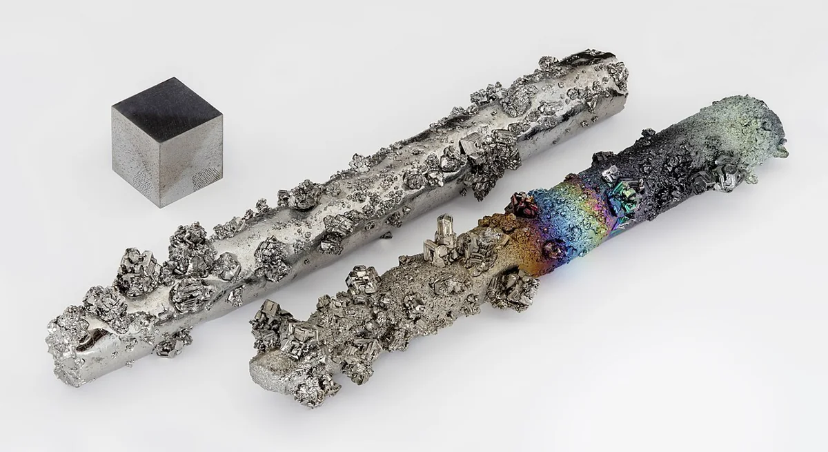 Tungsten metal rods with evaporated crystals and a scale cube